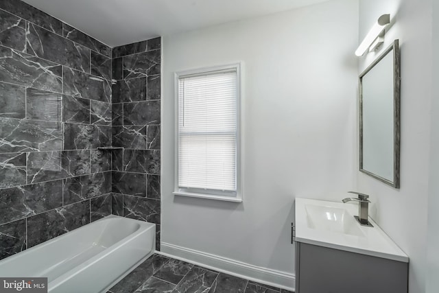 bathroom featuring a healthy amount of sunlight, vanity, and tiled shower / bath combo