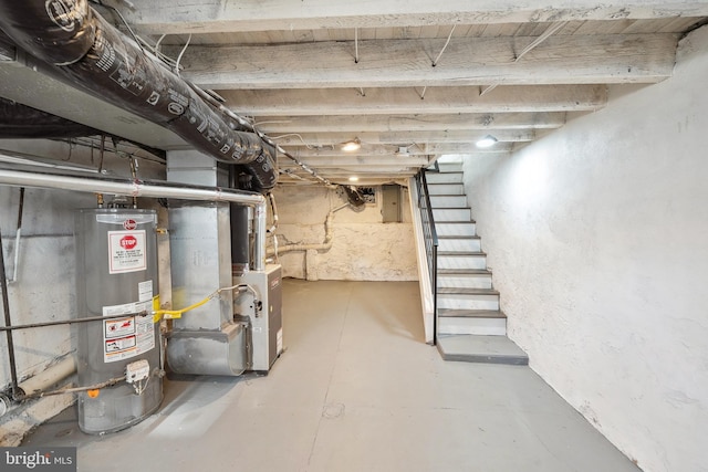 basement with gas water heater, heating unit, and electric panel