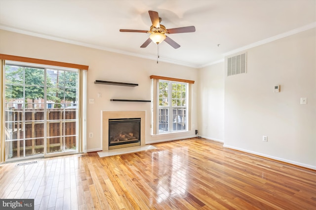 unfurnished living room with ornamental molding, light hardwood / wood-style floors, and ceiling fan