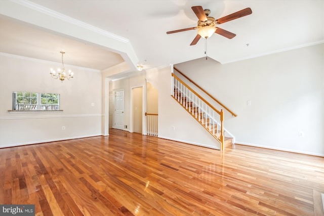 unfurnished living room with ornamental molding, ceiling fan with notable chandelier, and light hardwood / wood-style floors