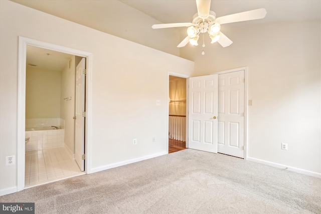 unfurnished bedroom with ceiling fan, ensuite bathroom, and carpet