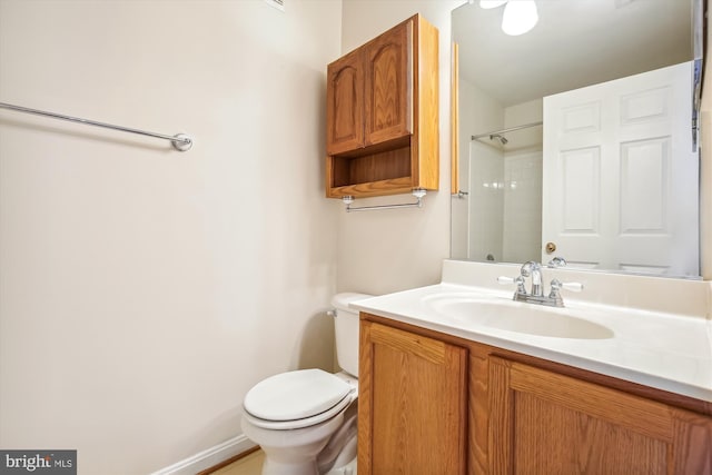 bathroom featuring walk in shower, vanity, and toilet