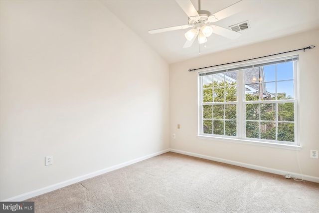 unfurnished room with lofted ceiling, plenty of natural light, carpet, and ceiling fan