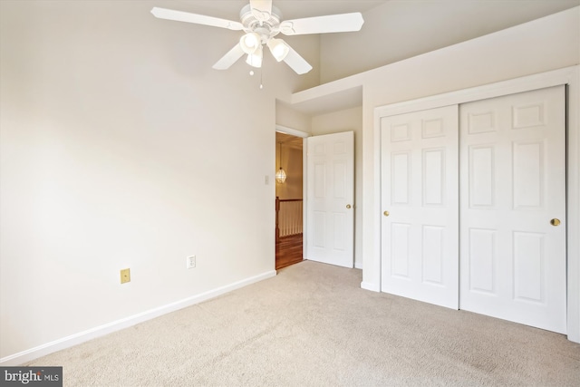 unfurnished bedroom featuring light colored carpet, ceiling fan, and a closet