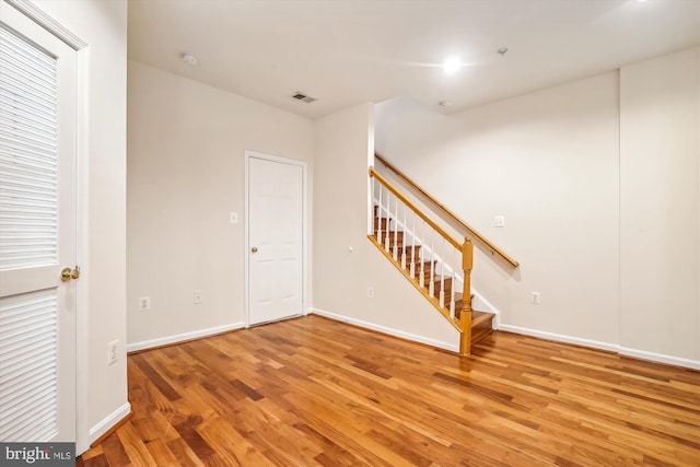 empty room with hardwood / wood-style flooring