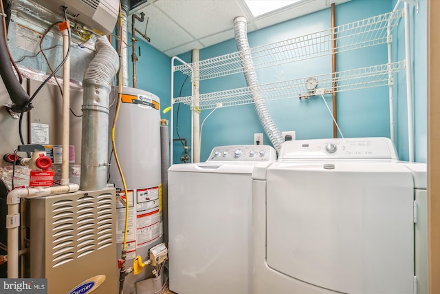 laundry area with water heater and washer and dryer