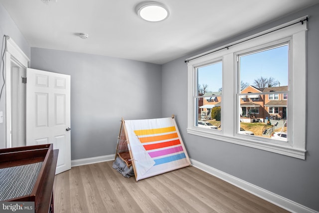 bedroom featuring baseboards and wood finished floors