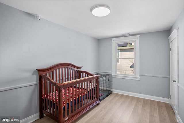 bedroom featuring baseboards and wood finished floors