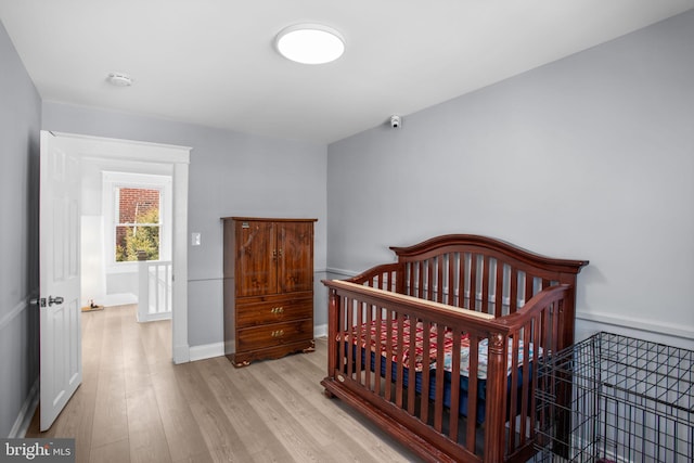 bedroom with baseboards and wood finished floors