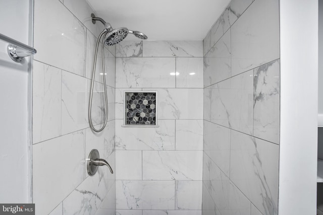 full bath with a tile shower