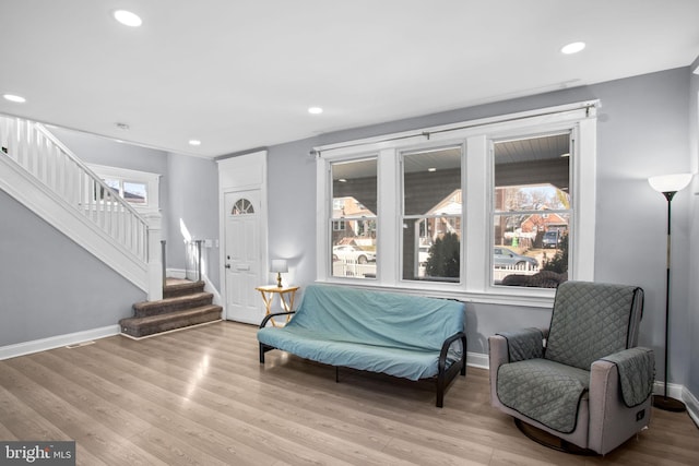 living area featuring recessed lighting, baseboards, wood finished floors, and stairs