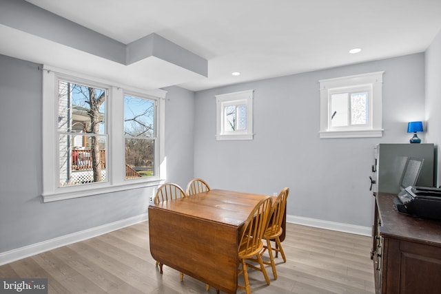 dining space featuring light wood-style flooring, recessed lighting, and baseboards