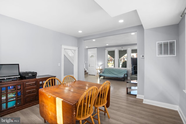 dining area with stairway, wood finished floors, visible vents, baseboards, and recessed lighting