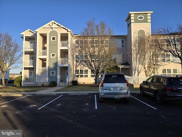 view of building exterior with uncovered parking