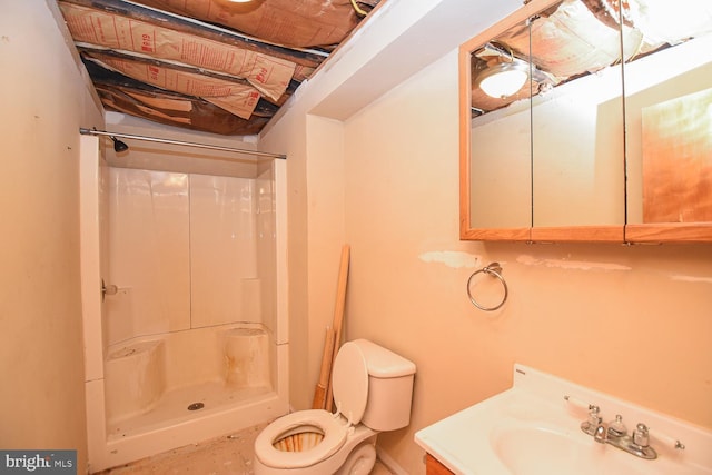 bathroom featuring walk in shower, vanity, and toilet