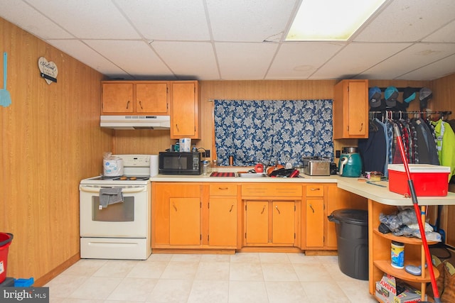 kitchen featuring wooden walls, a drop ceiling, and electric range