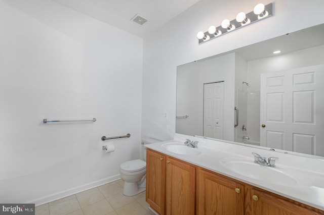 bathroom with vanity, toilet, and tile patterned flooring