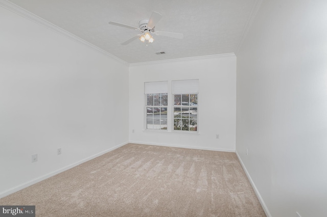 unfurnished room with crown molding, light colored carpet, and ceiling fan