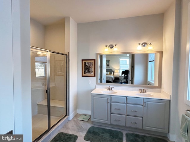 bathroom featuring vanity, a healthy amount of sunlight, and an enclosed shower