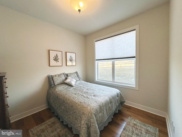 bedroom with dark wood-type flooring