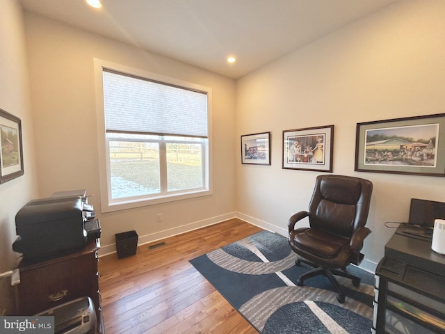 office space with hardwood / wood-style floors