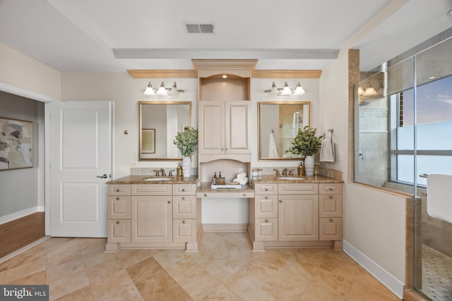 bathroom featuring a shower with door and vanity