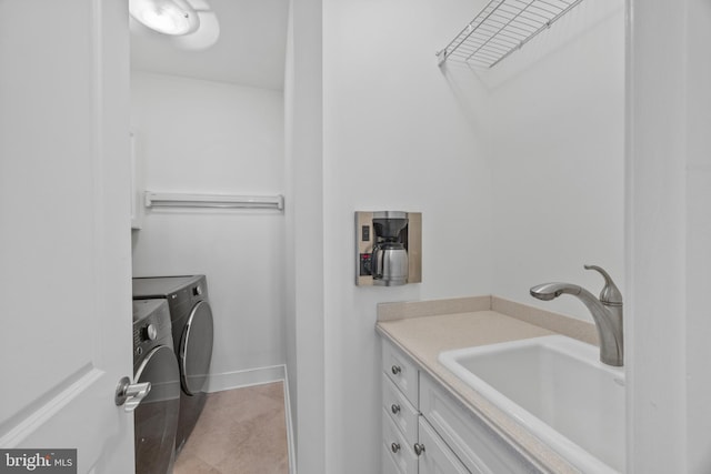 laundry room with cabinets, sink, light tile patterned floors, and independent washer and dryer