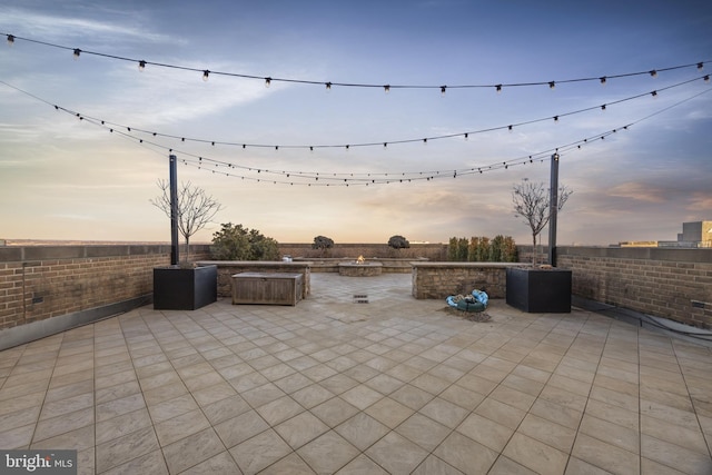 patio terrace at dusk featuring a jacuzzi