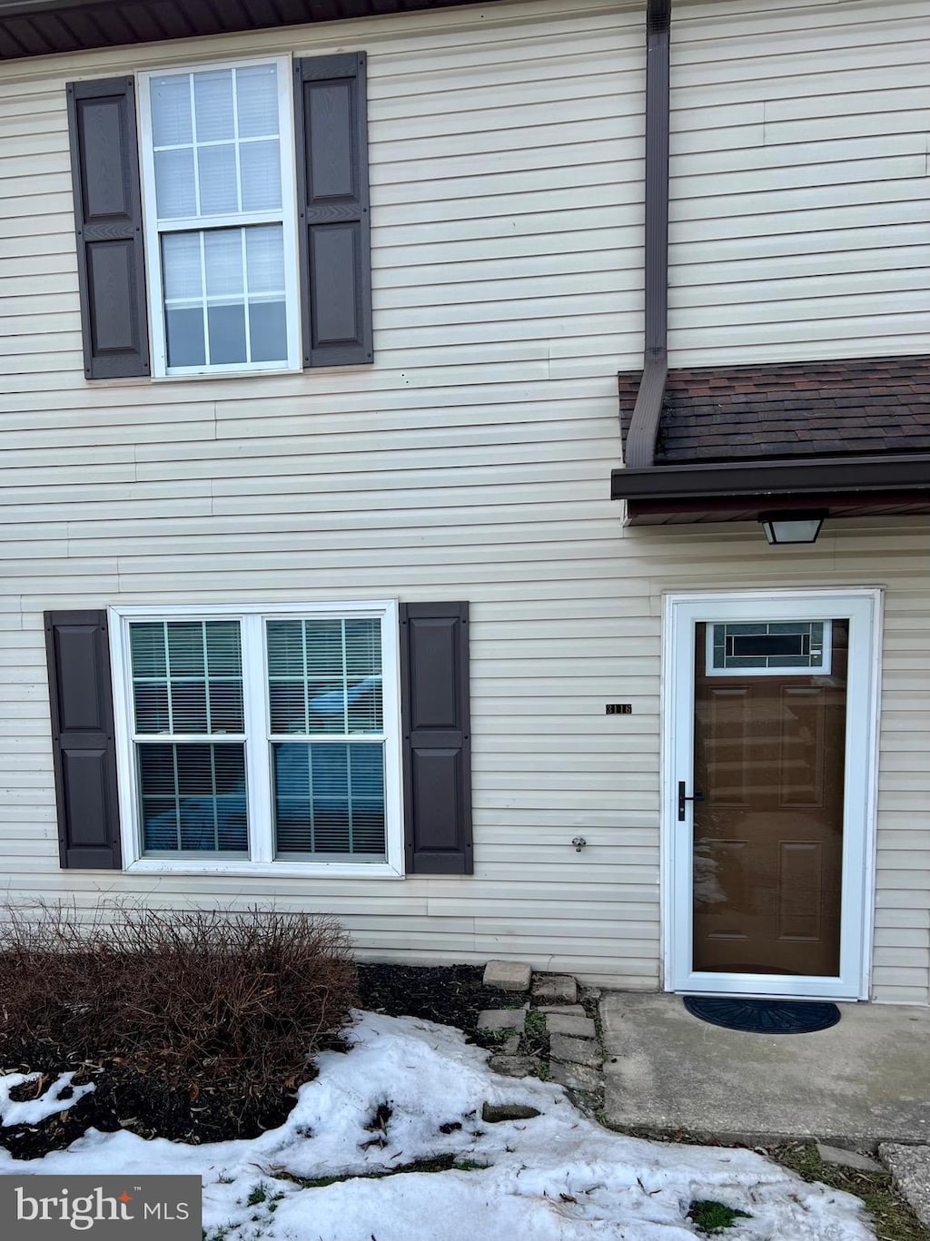 view of snow covered property entrance