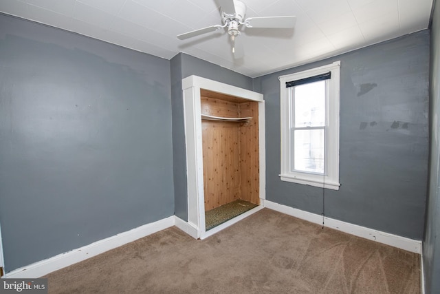 unfurnished bedroom featuring ceiling fan, carpet floors, and a closet