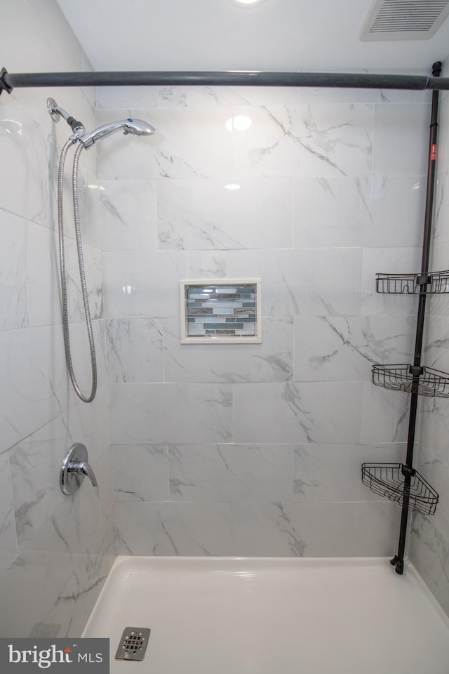 bathroom with a tile shower