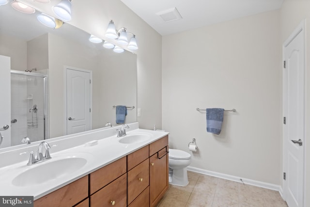 bathroom featuring vanity, a shower with shower door, tile patterned floors, and toilet