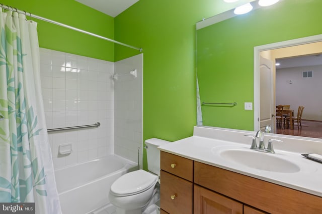 full bathroom featuring shower / tub combo with curtain, vanity, and toilet