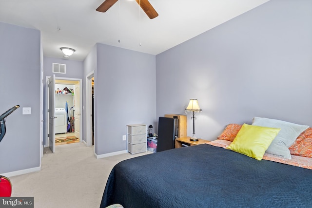 carpeted bedroom featuring ceiling fan and washer / dryer