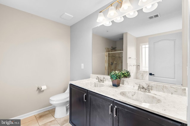 bathroom with vanity, toilet, a shower with shower door, and tile patterned flooring