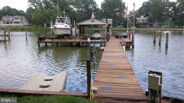 view of dock with a water view and boat lift