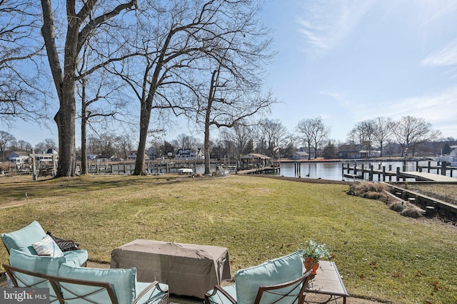 view of yard featuring a water view and a boat dock