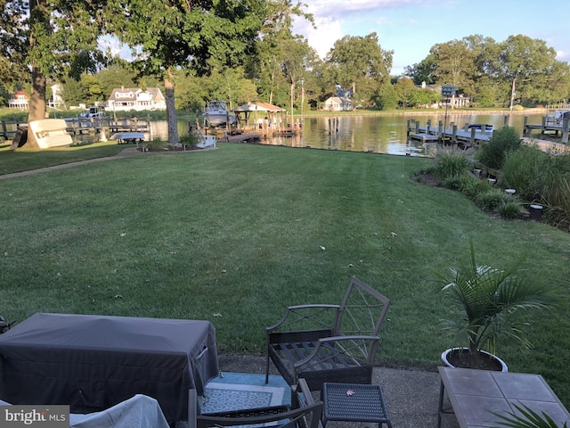 view of yard featuring a dock and a water view