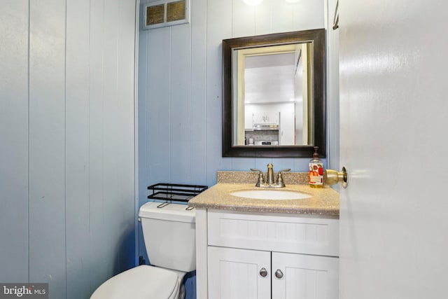 bathroom featuring vanity and toilet