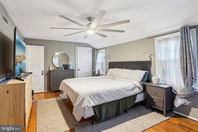 bedroom with vaulted ceiling, ceiling fan, and light hardwood / wood-style floors