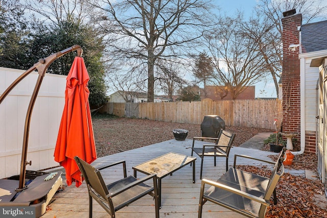 wooden deck featuring a grill