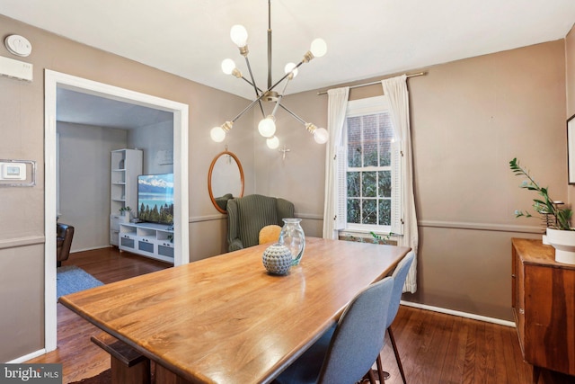 dining area featuring an inviting chandelier and dark hardwood / wood-style flooring