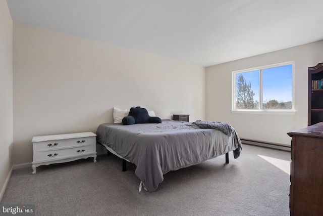 carpeted bedroom with a baseboard heating unit