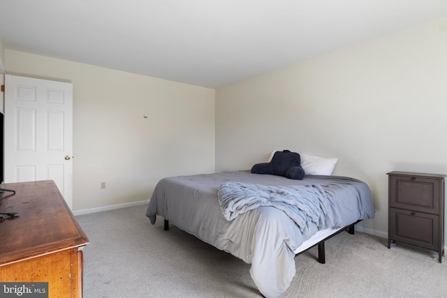 bedroom with light colored carpet