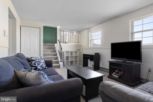 carpeted living room with a baseboard radiator