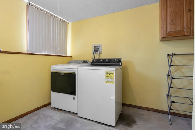 laundry area featuring cabinets and washer and clothes dryer