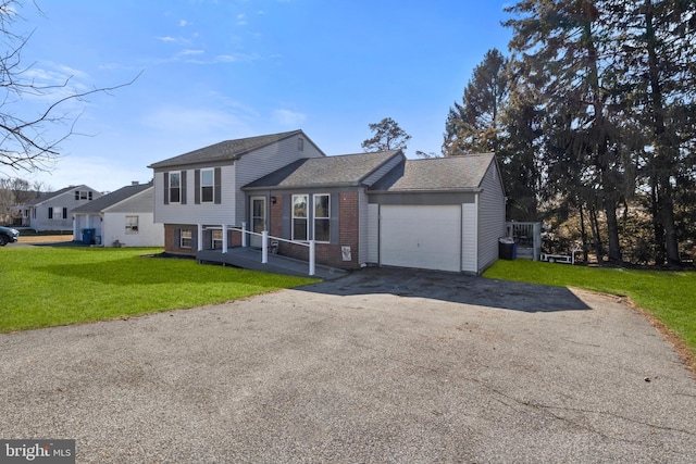 split level home featuring a front yard and a garage