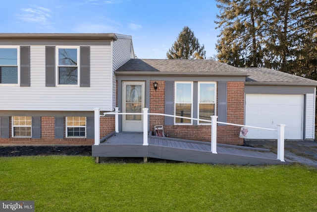 tri-level home featuring a garage and a front lawn