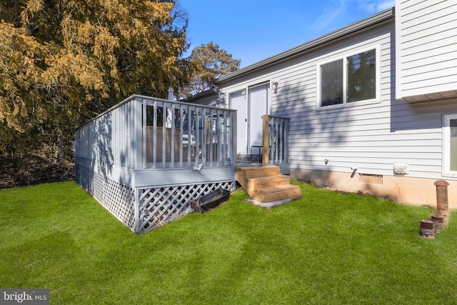 rear view of house with a lawn and a wooden deck