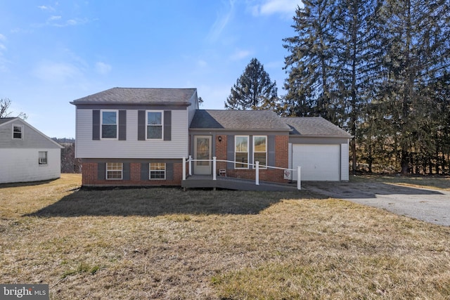 split level home with a garage and a front lawn